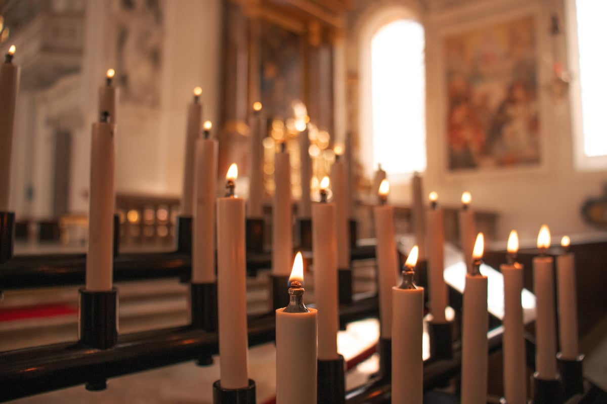 Sacred prayer candles glowing in reverent atmosphere